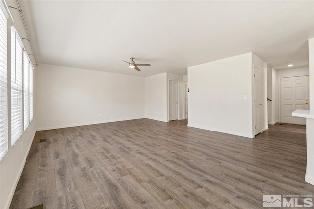 7753 Tulear St, Reno, NV 89506 - unfurnished living room featuring ceiling fan, wood finished floors, and baseboards