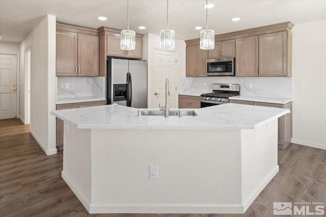 7753 Tulear St, Reno, NV 89506 - kitchen with appliances with stainless steel finishes, a sink, a kitchen island with sink, dark wood finished floors, and baseboards