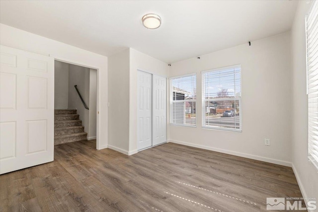 7753 Tulear St, Reno, NV 89506 - unfurnished bedroom with wood finished floors, baseboards, and a closet