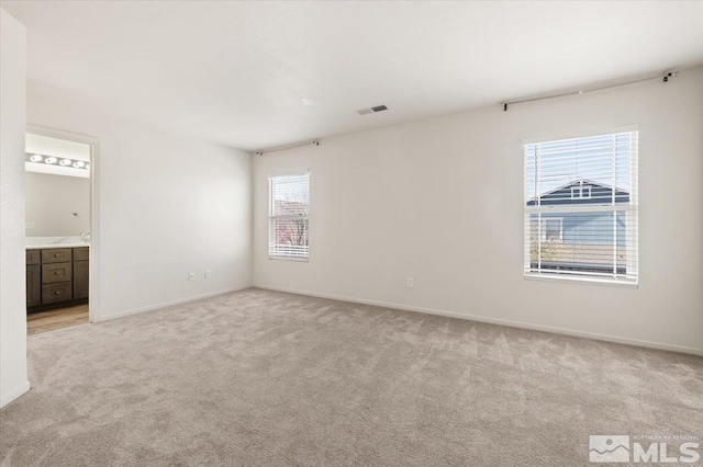 7753 Tulear St, Reno, NV 89506 - spare room featuring light colored carpet, healthy amount of natural light, and baseboards