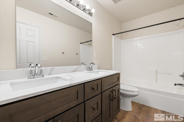 7753 Tulear St, Reno, NV 89506 - bathroom with wood finished floors, toilet, double vanity, and shower / bath combination