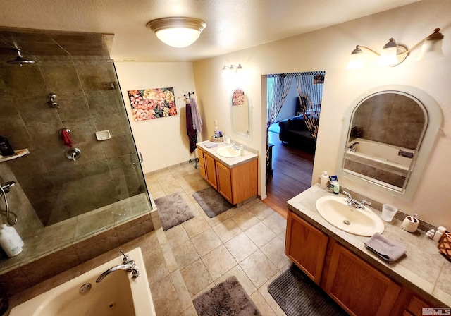 495 Burntwood St, Fallon, NV 89406 - full bathroom with a stall shower, vanity, a jetted tub, and tile patterned floors
