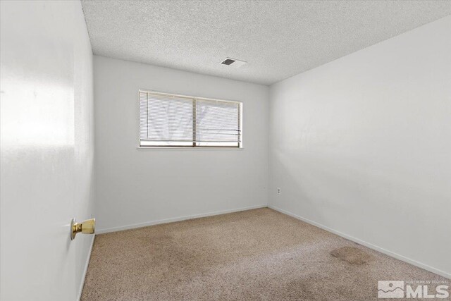 2165 Kietzke Ln Unit D, Reno, NV 89502 - empty room featuring carpet, a textured ceiling, and baseboards