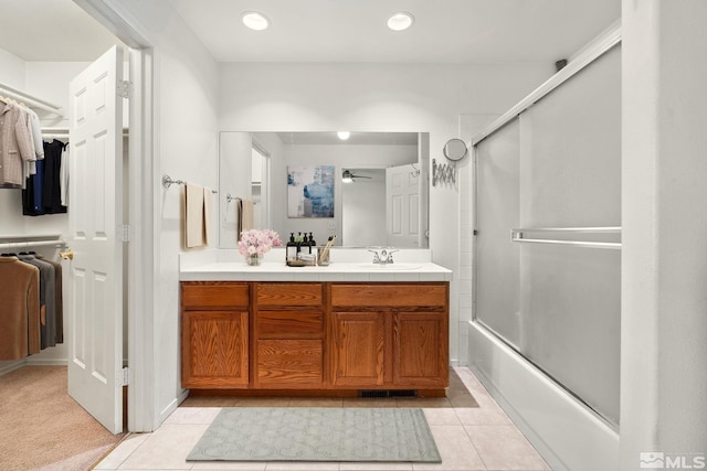 4251 Furgerson Ranch Rd, Carson City, NV 89701 - bathroom featuring vanity, combined bath / shower with glass door, a spacious closet, a ceiling fan, and tile patterned floors
