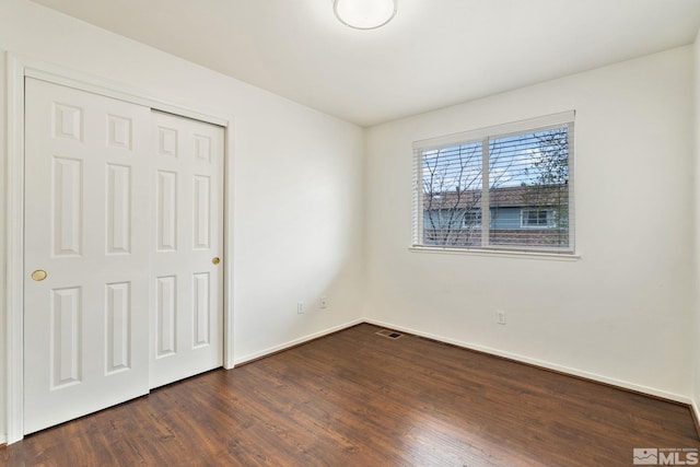 4251 Furgerson Ranch Rd, Carson City, NV 89701 - unfurnished bedroom with dark wood finished floors, a closet, and baseboards