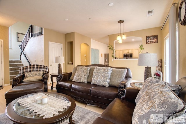 2078 Tivoli, Sparks, NV 89434 - living room with light wood finished floors, stairway, and arched walkways