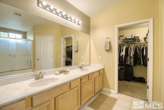 2078 Tivoli, Sparks, NV 89434 - full bathroom featuring tile patterned floors, double vanity, a shower with shower door, a spacious closet, and baseboards