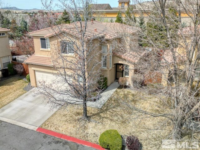 2078 Tivoli, Sparks, NV 89434 - view of front of house featuring stucco siding, an attached garage, driveway, and a tiled roof