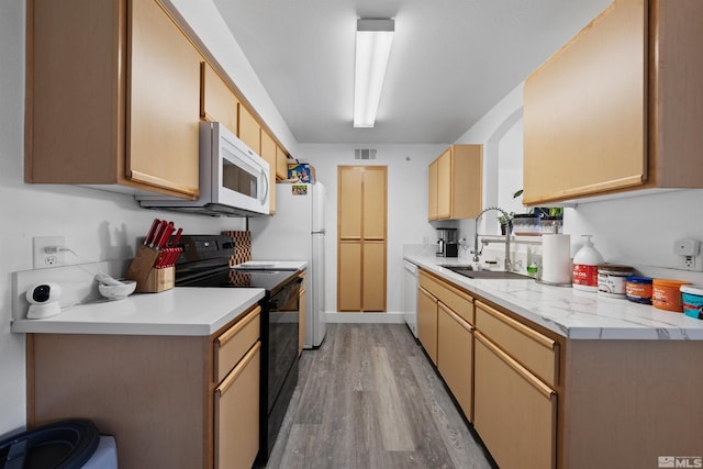6850 Sharlands Ave # W2137, Reno, NV 89523 - kitchen featuring white appliances, a sink, light wood-style flooring, and light countertops