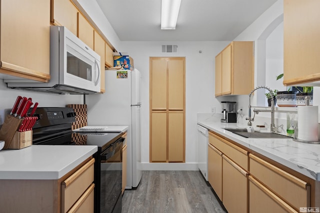 6850 Sharlands Ave # W2137, Reno, NV 89523 - kitchen featuring white appliances, a sink, light wood-style flooring, light countertops, and light brown cabinetry