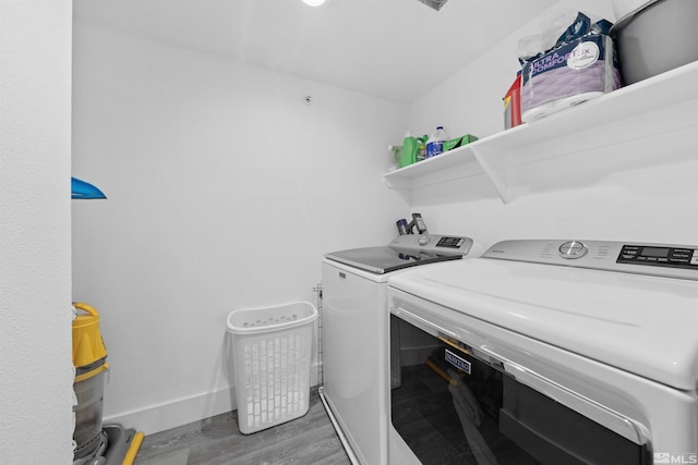 6850 Sharlands Ave # W2137, Reno, NV 89523 - washroom with washing machine and dryer, wood finished floors, and baseboards