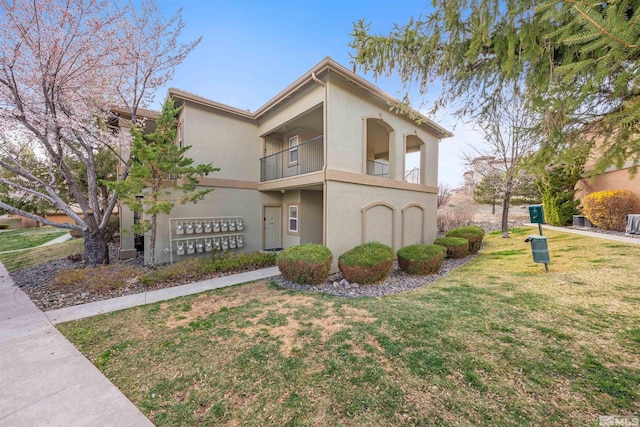 6850 Sharlands Ave # W2137, Reno, NV 89523 - view of front of house with a balcony, stucco siding, and a front yard