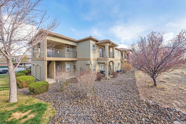 6850 Sharlands Ave # W2137, Reno, NV 89523 - view of home's exterior featuring a balcony, stucco siding, and central AC