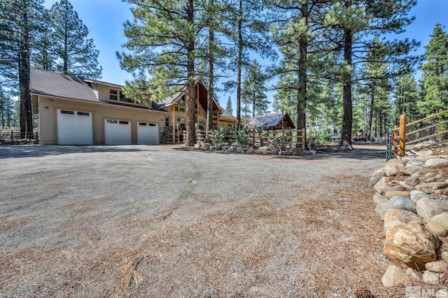 16375 Callahan Rd, Reno, NV 89511 - view of side of property featuring a garage, driveway, and fence
