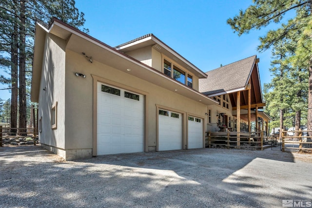 16375 Callahan Rd, Reno, NV 89511 - view of property exterior featuring a garage, stucco siding, driveway, and roof with shingles