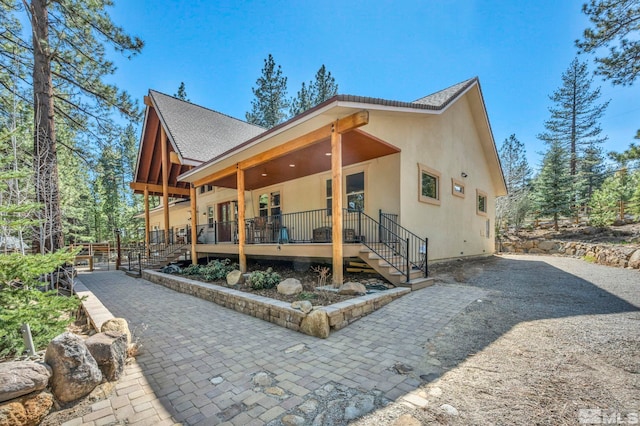 16375 Callahan Rd, Reno, NV 89511 - view of side of home with stucco siding, roof with shingles, and stairway