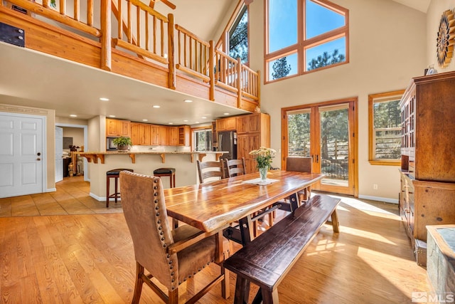 16375 Callahan Rd, Reno, NV 89511 - dining space with baseboards, light wood-style floors, recessed lighting, and a towering ceiling