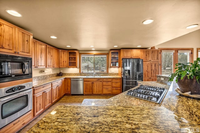 16375 Callahan Rd, Reno, NV 89511 - kitchen with stainless steel appliances, recessed lighting, a sink, glass insert cabinets, and brown cabinets
