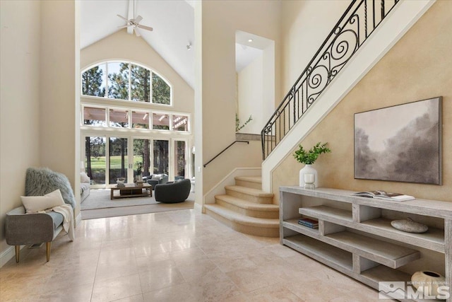 5680 Lausanne Dr, Reno, NV 89511 - entryway with high vaulted ceiling, stairs, baseboards, and ceiling fan
