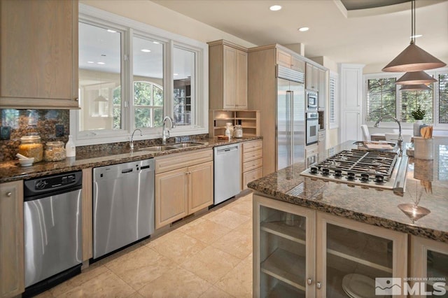 5680 Lausanne Dr, Reno, NV 89511 - kitchen with built in appliances, a sink, decorative backsplash, recessed lighting, and dark stone countertops