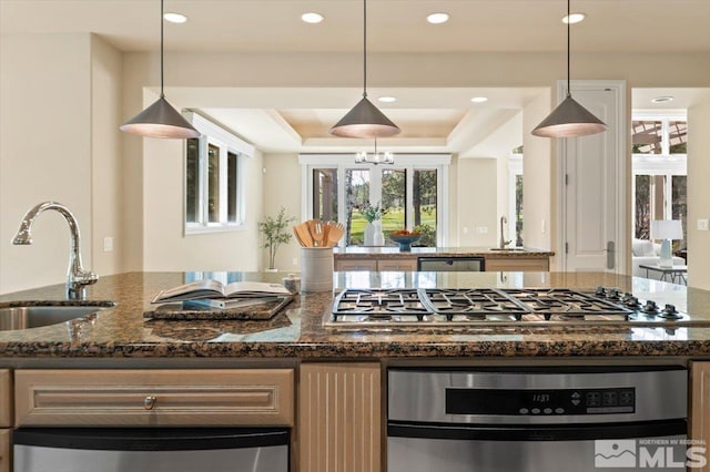 5680 Lausanne Dr, Reno, NV 89511 - kitchen featuring a sink, stainless steel gas stovetop, a tray ceiling, recessed lighting, and hanging light fixtures