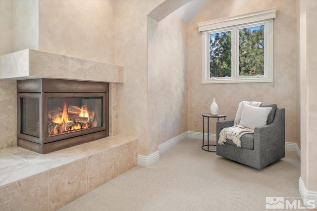 5680 Lausanne Dr, Reno, NV 89511 - living area with carpet floors, baseboards, a tile fireplace, and arched walkways