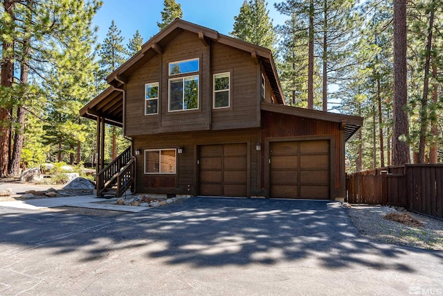 877 Northwood Blvd Unit 2, Incline Village, NV 89451 - view of front of house with a garage, asphalt driveway, fence, and stairway
