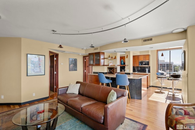 280 Island Ave Apt 802, Reno, NV 89501 - living room featuring light wood-style floors and baseboards