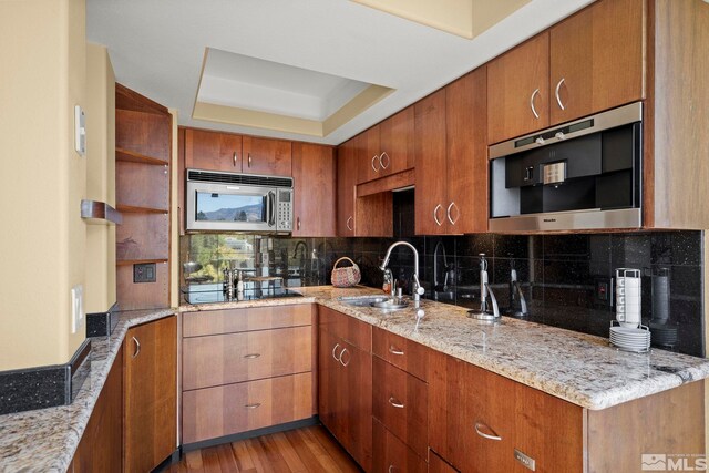 280 Island Ave Apt 802, Reno, NV 89501 - kitchen featuring stainless steel microwave, open shelves, a sink, and brown cabinets