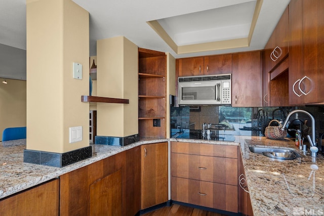 280 Island Ave Apt 802, Reno, NV 89501 - kitchen with stainless steel microwave, a sink, light stone counters, and backsplash