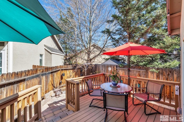 5310 Village Meadows Dr, Sparks, NV 89436 - wooden terrace with outdoor dining space and a fenced backyard