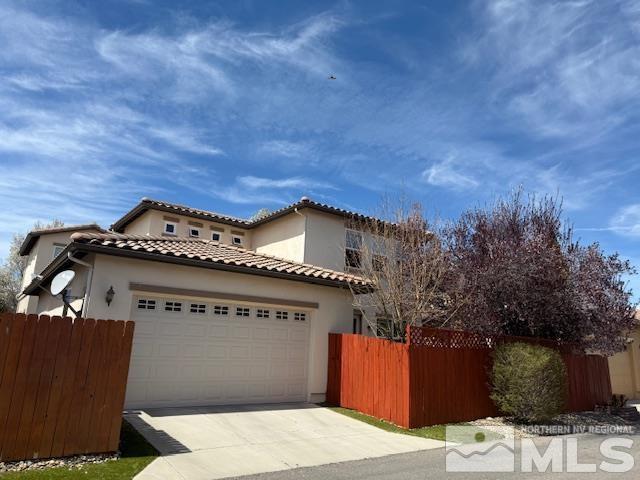 1769 La Cita Way, Minden, NV 89423 - mediterranean / spanish home featuring stucco siding, concrete driveway, an attached garage, and fence