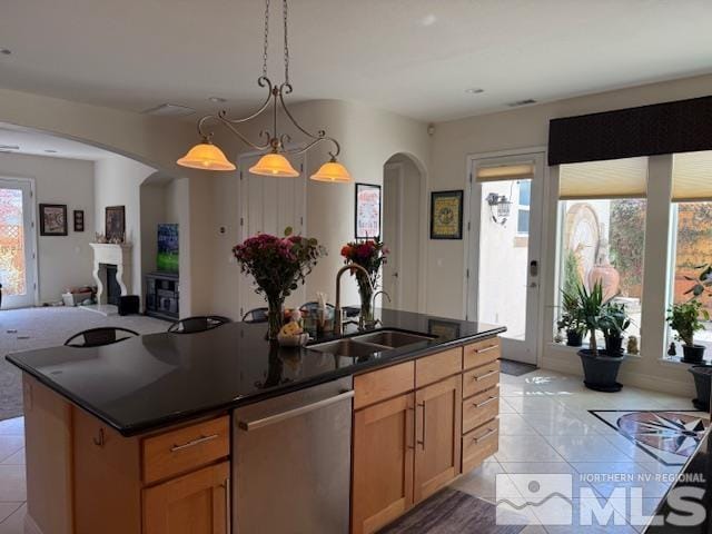 1769 La Cita Way, Minden, NV 89423 - kitchen with stainless steel dishwasher, light tile patterned floors, arched walkways, and a sink