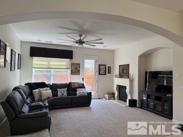 1769 La Cita Way, Minden, NV 89423 - carpeted living area with ceiling fan, arched walkways, and a glass covered fireplace
