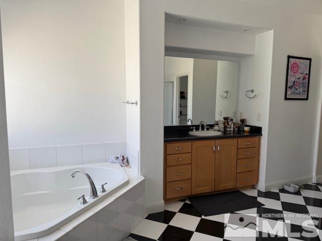 1769 La Cita Way, Minden, NV 89423 - bathroom featuring tile patterned floors, a garden tub, and vanity