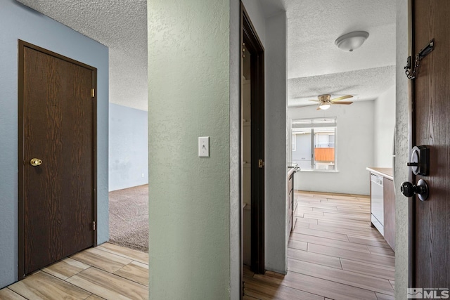 4604 Neil Rd Unit 122, Reno, NV 89502 - hallway featuring a textured ceiling, a textured wall, and wood finish floors