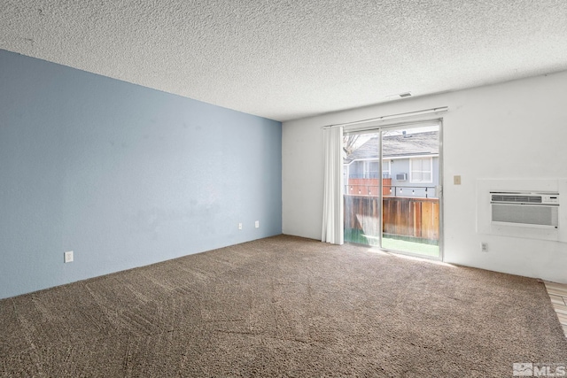 4604 Neil Rd Unit 122, Reno, NV 89502 - spare room with a wall mounted AC, carpet floors, and a textured ceiling