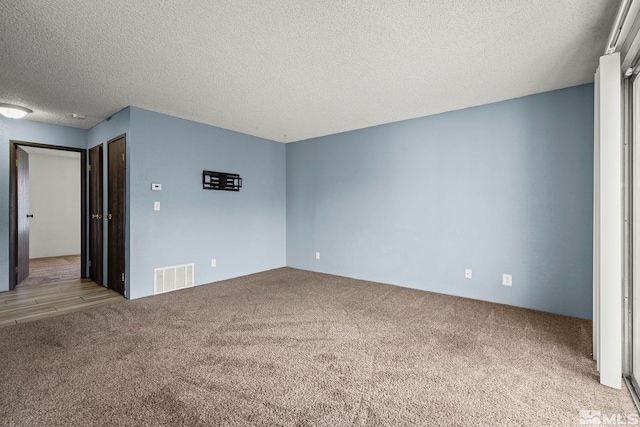 4604 Neil Rd Unit 122, Reno, NV 89502 - carpeted empty room with a textured ceiling