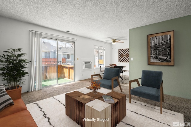 4604 Neil Rd Unit 122, Reno, NV 89502 - carpeted living area featuring a textured ceiling, a wall mounted air conditioner, and ceiling fan