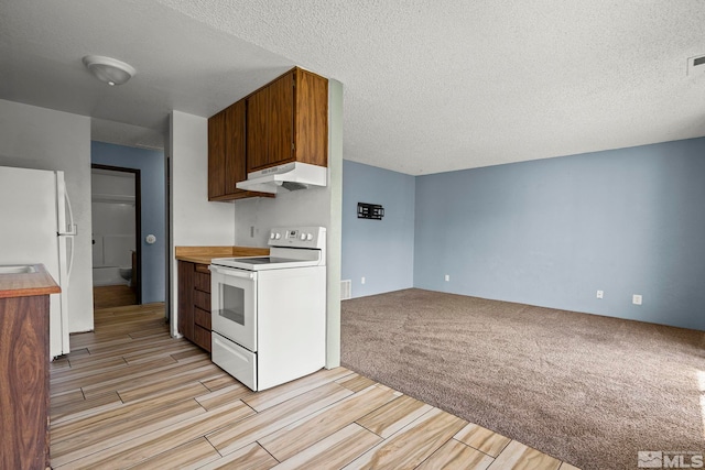 4604 Neil Rd Unit 122, Reno, NV 89502 - kitchen with white appliances, under cabinet range hood, wood tiled floors, light countertops, and a textured ceiling