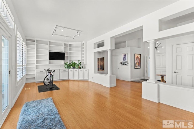 5103 Tucumcari Cir, Reno, NV 89511 - workout room featuring decorative columns, light wood-type flooring, built in shelves, and baseboards