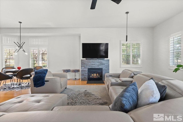 5103 Tucumcari Cir, Reno, NV 89511 - living room with light wood finished floors, ceiling fan, and a stone fireplace