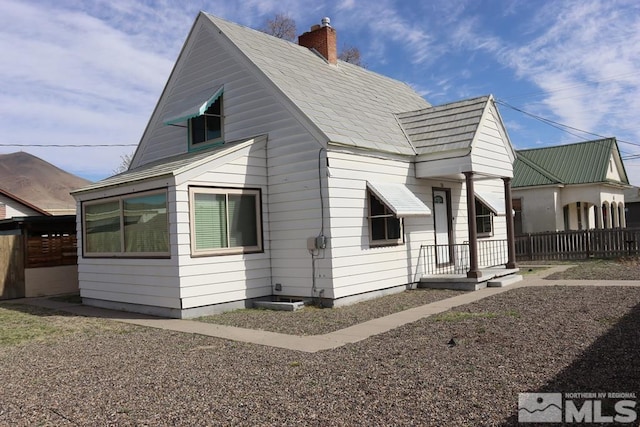 136 W First St, Winnemucca, NV 89445 - rear view of property featuring a chimney and fence