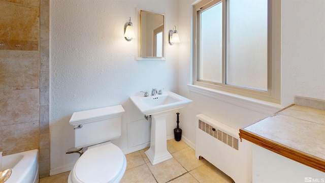 136 W First St, Winnemucca, NV 89445 - full bath with radiator heating unit, tile patterned flooring, a bath, toilet, and a shower