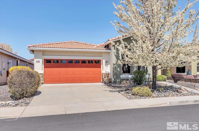 2140 Avella Dr, Sparks, NV 89434 - view of front facade featuring a garage, stucco siding, concrete driveway, and a tiled roof