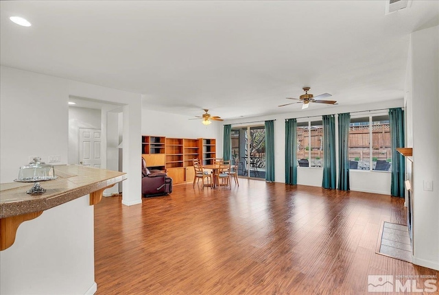 2140 Avella Dr, Sparks, NV 89434 - living area featuring healthy amount of natural light, a ceiling fan, wood finished floors, and recessed lighting