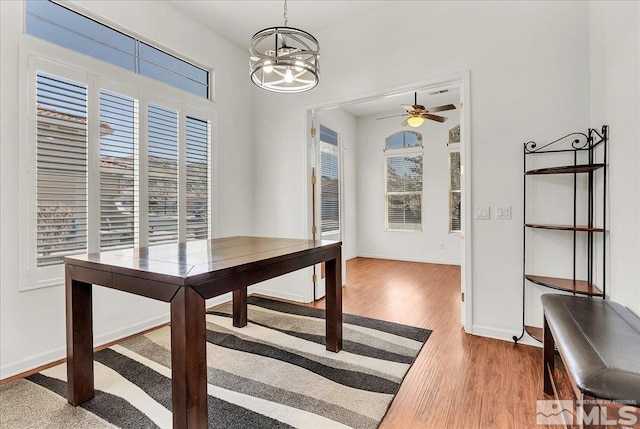 2140 Avella Dr, Sparks, NV 89434 - unfurnished dining area with a chandelier, light wood-style floors, a ceiling fan, and baseboards