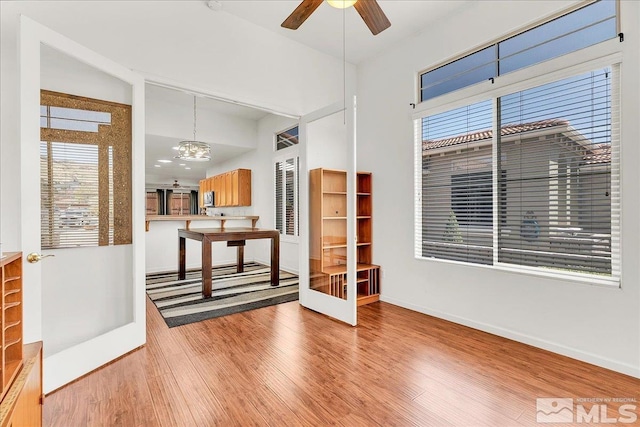 2140 Avella Dr, Sparks, NV 89434 - unfurnished room featuring wood finished floors, a ceiling fan, a chandelier, and baseboards