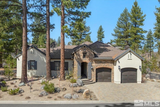 20605 Parc Foret Dr, Reno, NV 89511 - view of front of home featuring stone siding, stucco siding, a garage, and decorative driveway