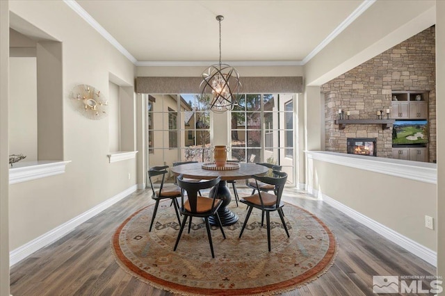 20605 Parc Foret Dr, Reno, NV 89511 - dining space with a chandelier, wood finished floors, a fireplace, baseboards, and crown molding